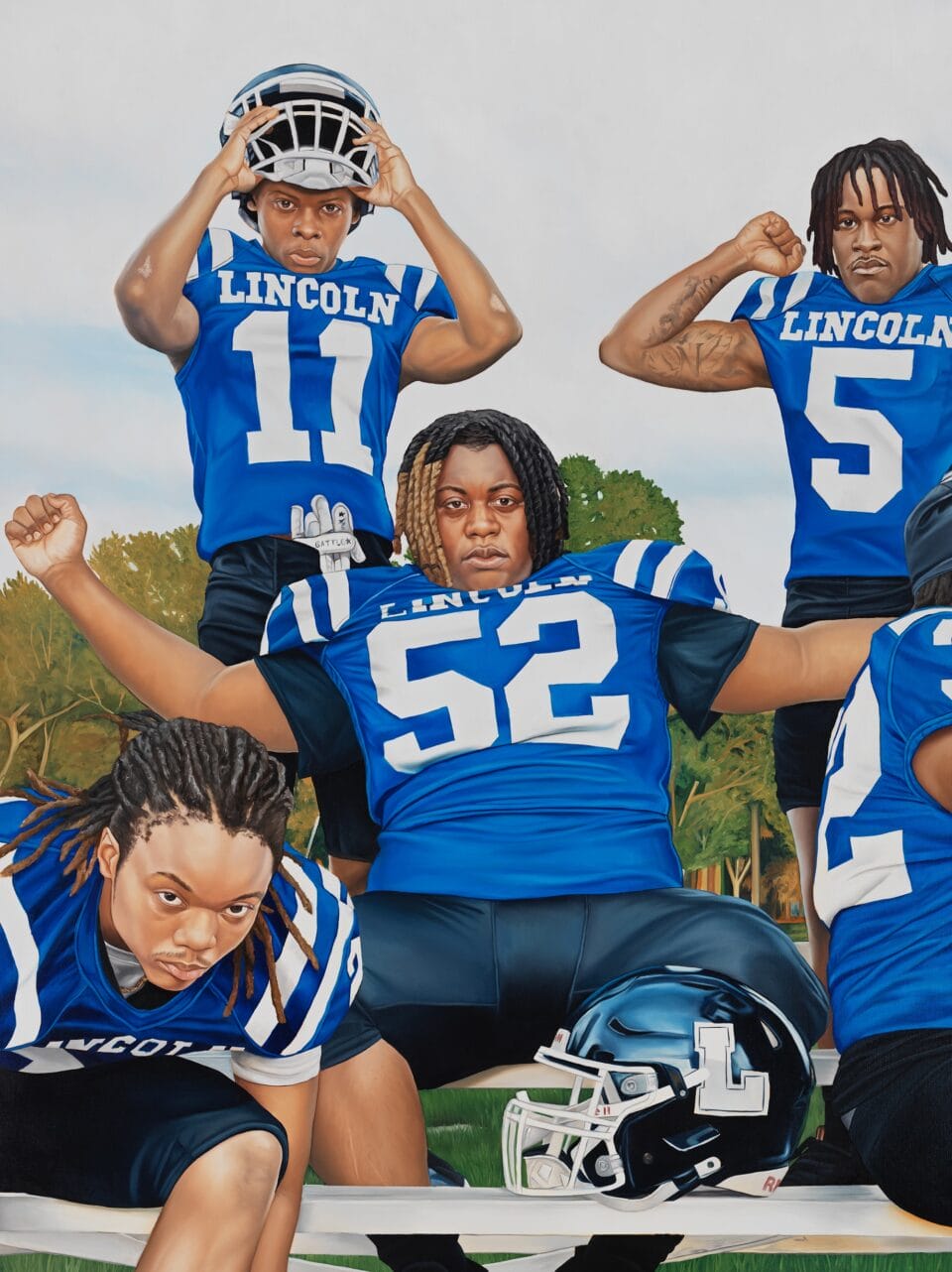 a detail of a wide, horizontal triptych of football players and a coach in blue uniforms, sitting or standing near bleachers and getting suited up, some looking directly at the viewer, with a central figure opening his arms wide